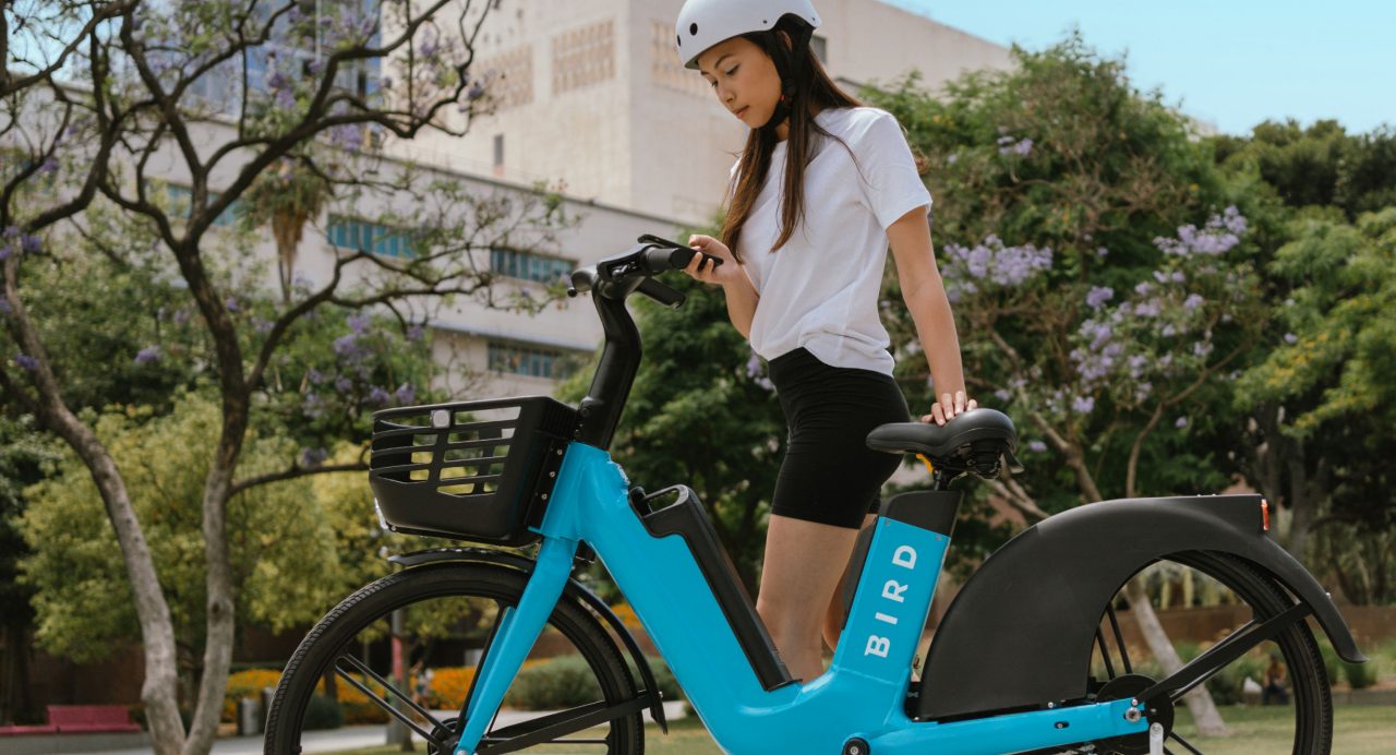 Lady riding Bird bike